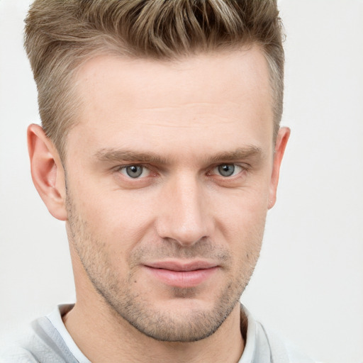 Joyful white young-adult male with short  brown hair and grey eyes