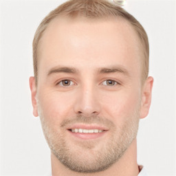 Joyful white young-adult male with short  brown hair and grey eyes