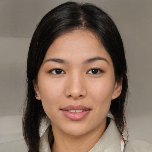 Joyful asian young-adult female with medium  black hair and brown eyes