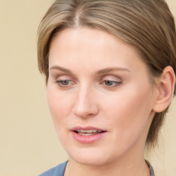 Joyful white young-adult female with medium  brown hair and blue eyes