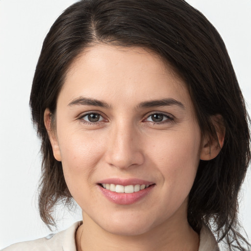 Joyful white young-adult female with medium  brown hair and brown eyes