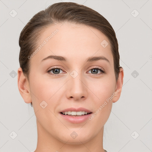 Joyful white young-adult female with short  brown hair and grey eyes