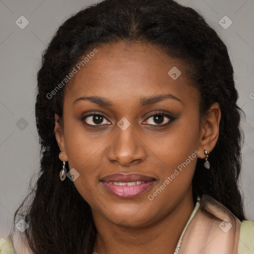 Joyful black young-adult female with long  brown hair and brown eyes