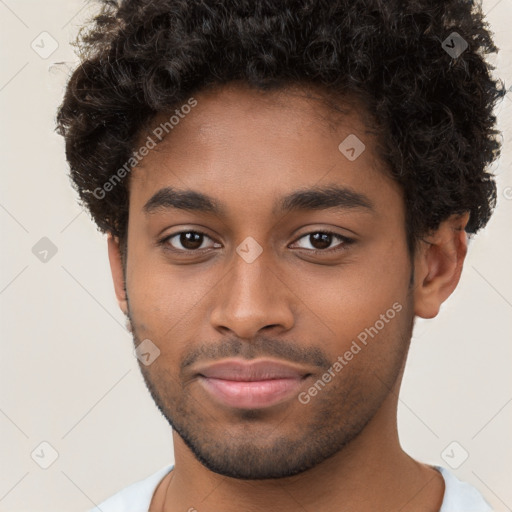 Joyful black young-adult male with short  brown hair and brown eyes