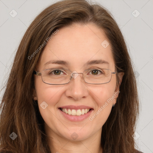 Joyful white adult female with long  brown hair and green eyes