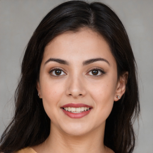 Joyful white young-adult female with long  brown hair and brown eyes