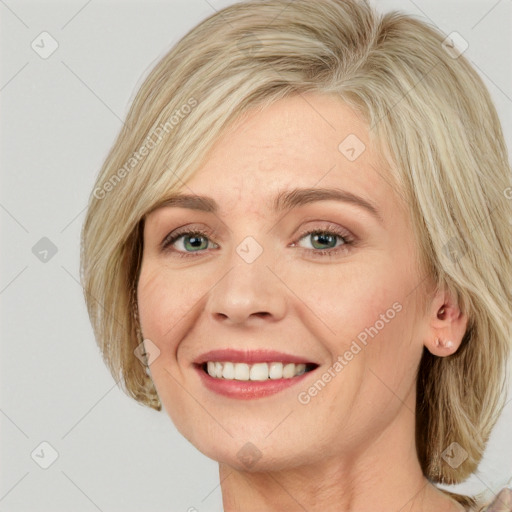 Joyful white adult female with medium  brown hair and blue eyes