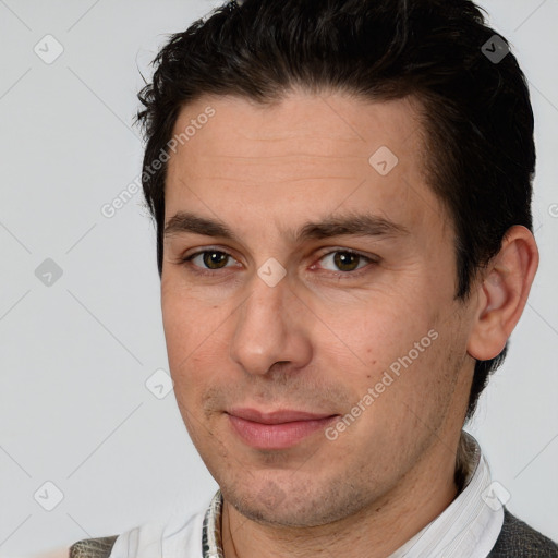 Joyful white adult male with short  brown hair and brown eyes