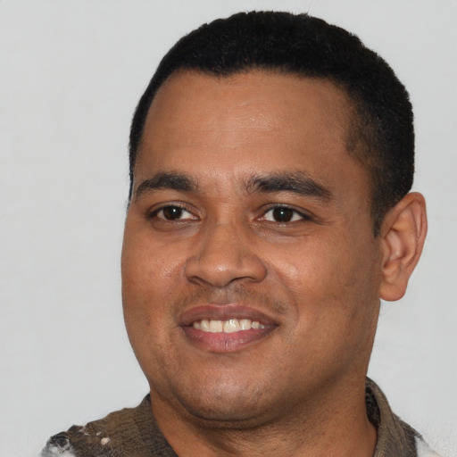 Joyful latino young-adult male with short  black hair and brown eyes