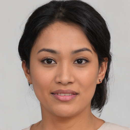 Joyful latino young-adult female with medium  black hair and brown eyes