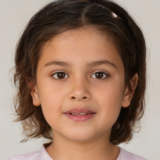 Joyful white child female with medium  brown hair and brown eyes