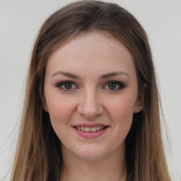 Joyful white young-adult female with long  brown hair and grey eyes