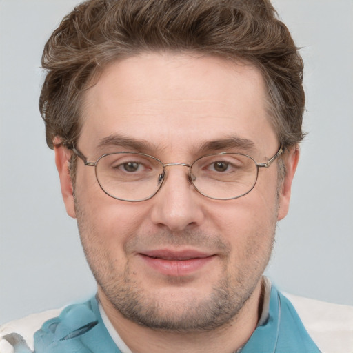 Joyful white adult male with short  brown hair and grey eyes