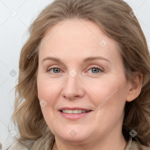 Joyful white adult female with medium  brown hair and blue eyes