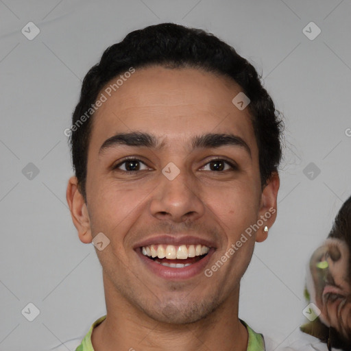 Joyful white young-adult male with short  black hair and brown eyes