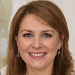 Joyful white adult female with long  brown hair and grey eyes