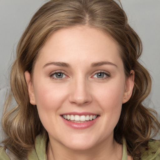 Joyful white young-adult female with medium  brown hair and grey eyes