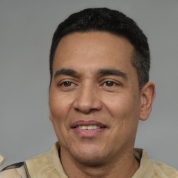 Joyful latino adult male with short  black hair and brown eyes