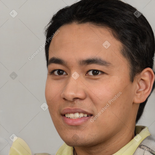 Joyful white young-adult male with short  black hair and brown eyes