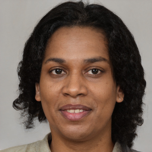 Joyful black adult female with medium  black hair and brown eyes
