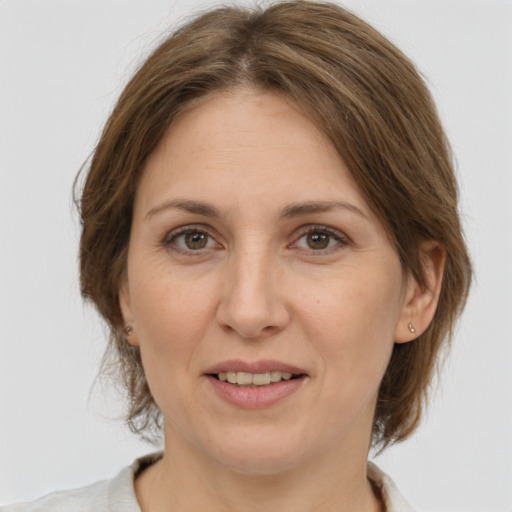 Joyful white adult female with medium  brown hair and brown eyes