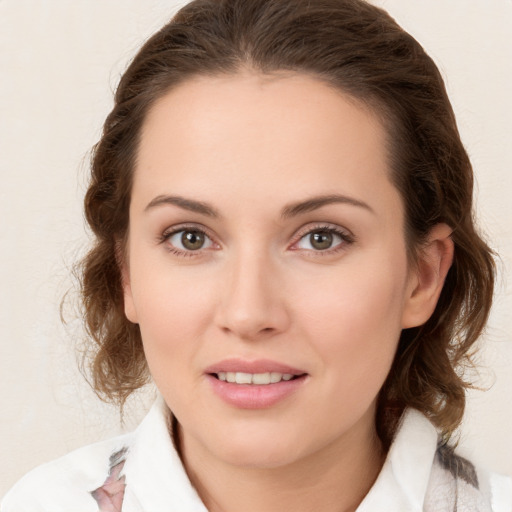 Joyful white young-adult female with medium  brown hair and green eyes