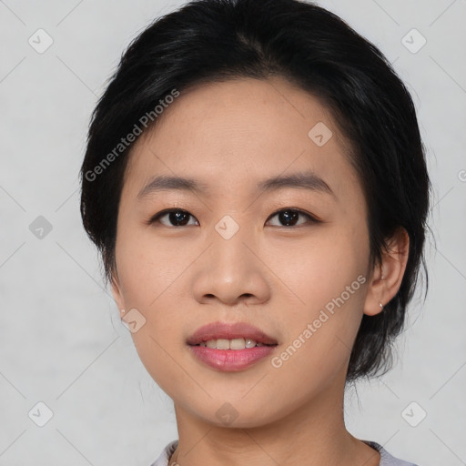 Joyful asian young-adult female with medium  black hair and brown eyes