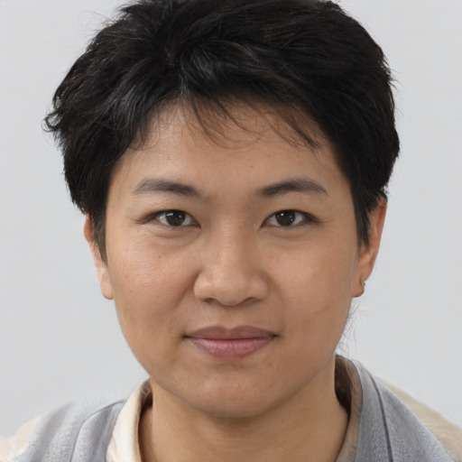 Joyful asian young-adult female with short  black hair and brown eyes