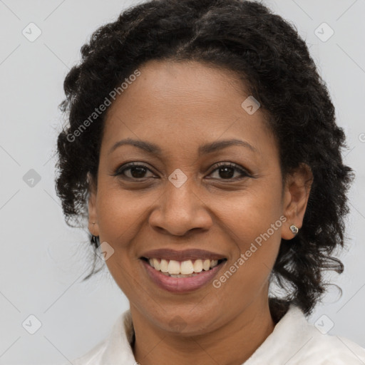 Joyful black adult female with medium  brown hair and brown eyes