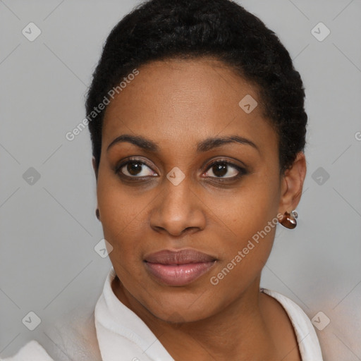 Joyful black young-adult female with short  black hair and brown eyes