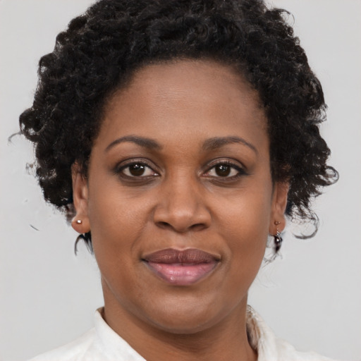 Joyful black adult female with short  brown hair and brown eyes