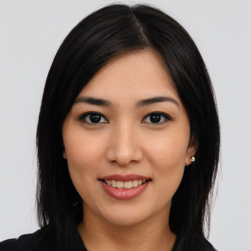 Joyful asian young-adult female with long  black hair and brown eyes