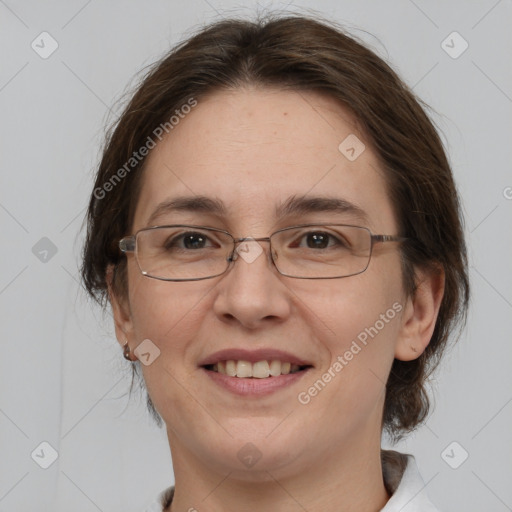 Joyful white adult female with medium  brown hair and brown eyes