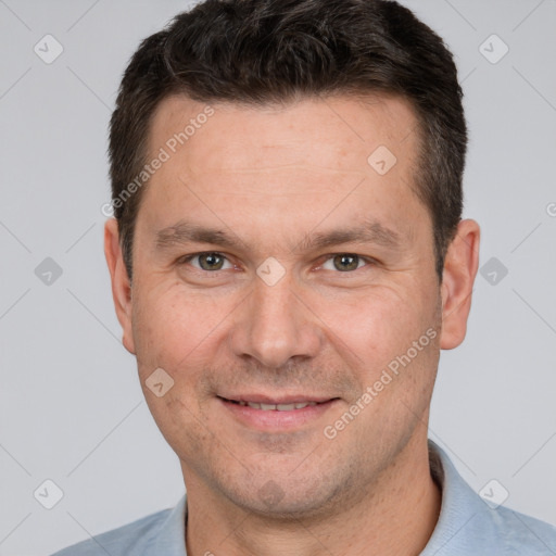 Joyful white adult male with short  brown hair and brown eyes