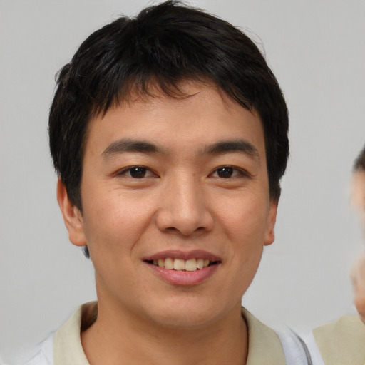 Joyful asian young-adult male with short  brown hair and brown eyes