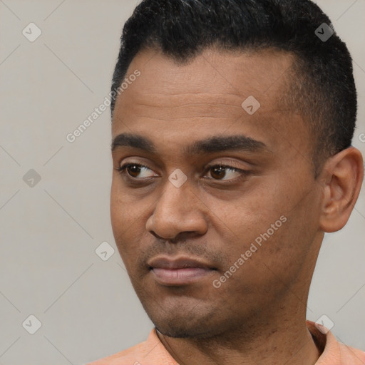 Joyful latino young-adult male with short  black hair and brown eyes