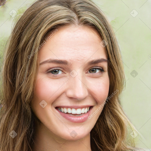 Joyful white young-adult female with long  brown hair and green eyes