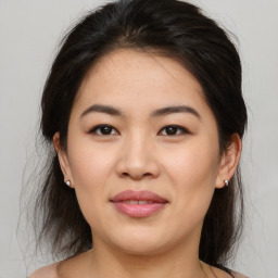 Joyful asian young-adult female with medium  brown hair and brown eyes