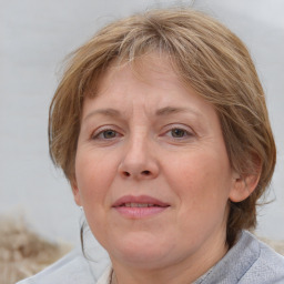 Joyful white adult female with medium  brown hair and blue eyes