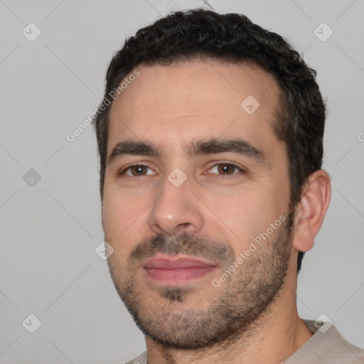 Joyful white young-adult male with short  black hair and brown eyes