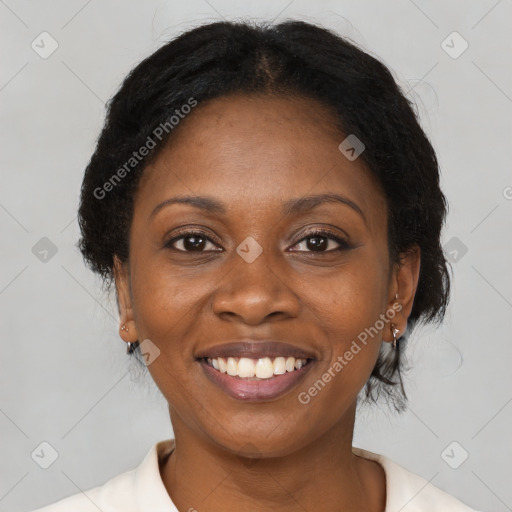 Joyful black adult female with medium  brown hair and brown eyes