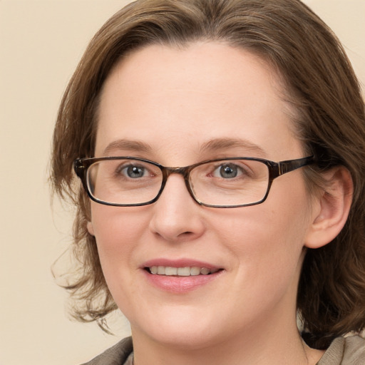 Joyful white adult female with medium  brown hair and blue eyes