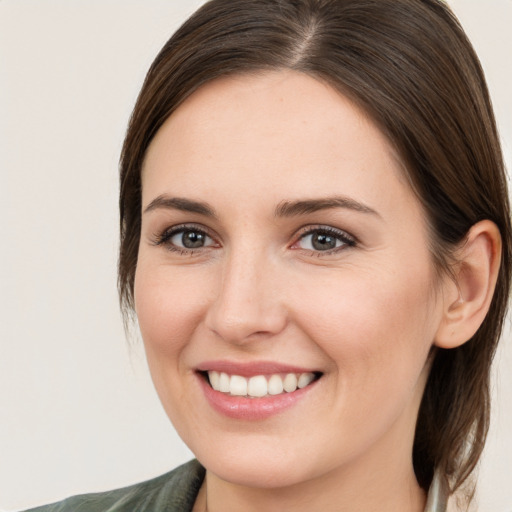 Joyful white young-adult female with medium  brown hair and brown eyes