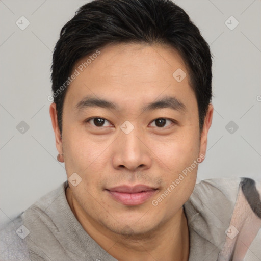 Joyful asian young-adult male with short  black hair and brown eyes