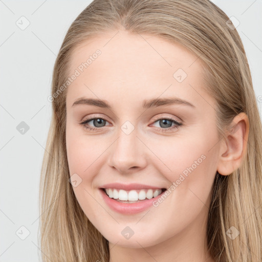 Joyful white young-adult female with long  brown hair and blue eyes