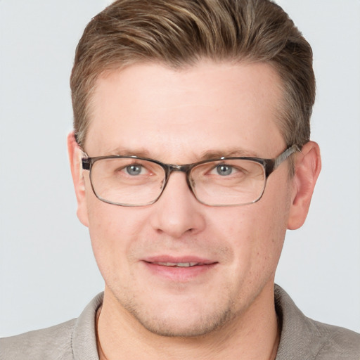 Joyful white adult male with short  brown hair and grey eyes