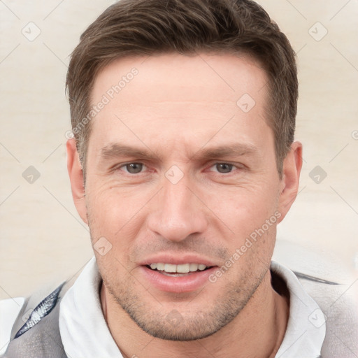 Joyful white adult male with short  brown hair and grey eyes