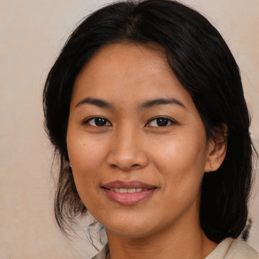 Joyful asian young-adult female with medium  brown hair and brown eyes