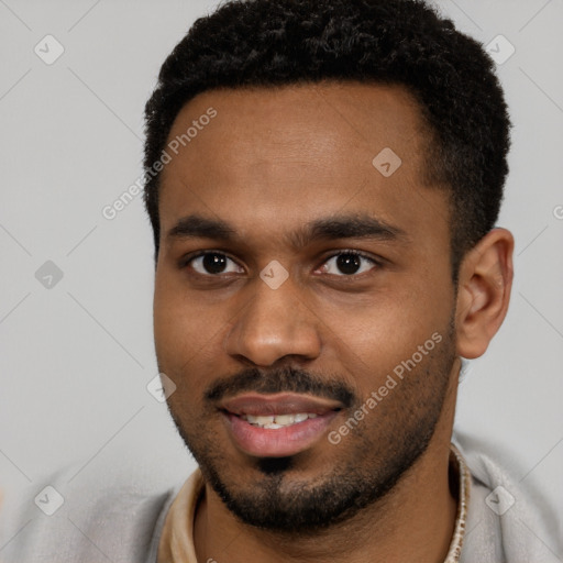 Joyful black young-adult male with short  black hair and brown eyes