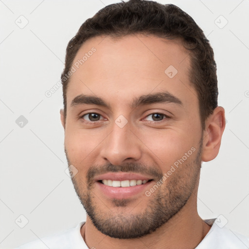 Joyful white young-adult male with short  brown hair and brown eyes